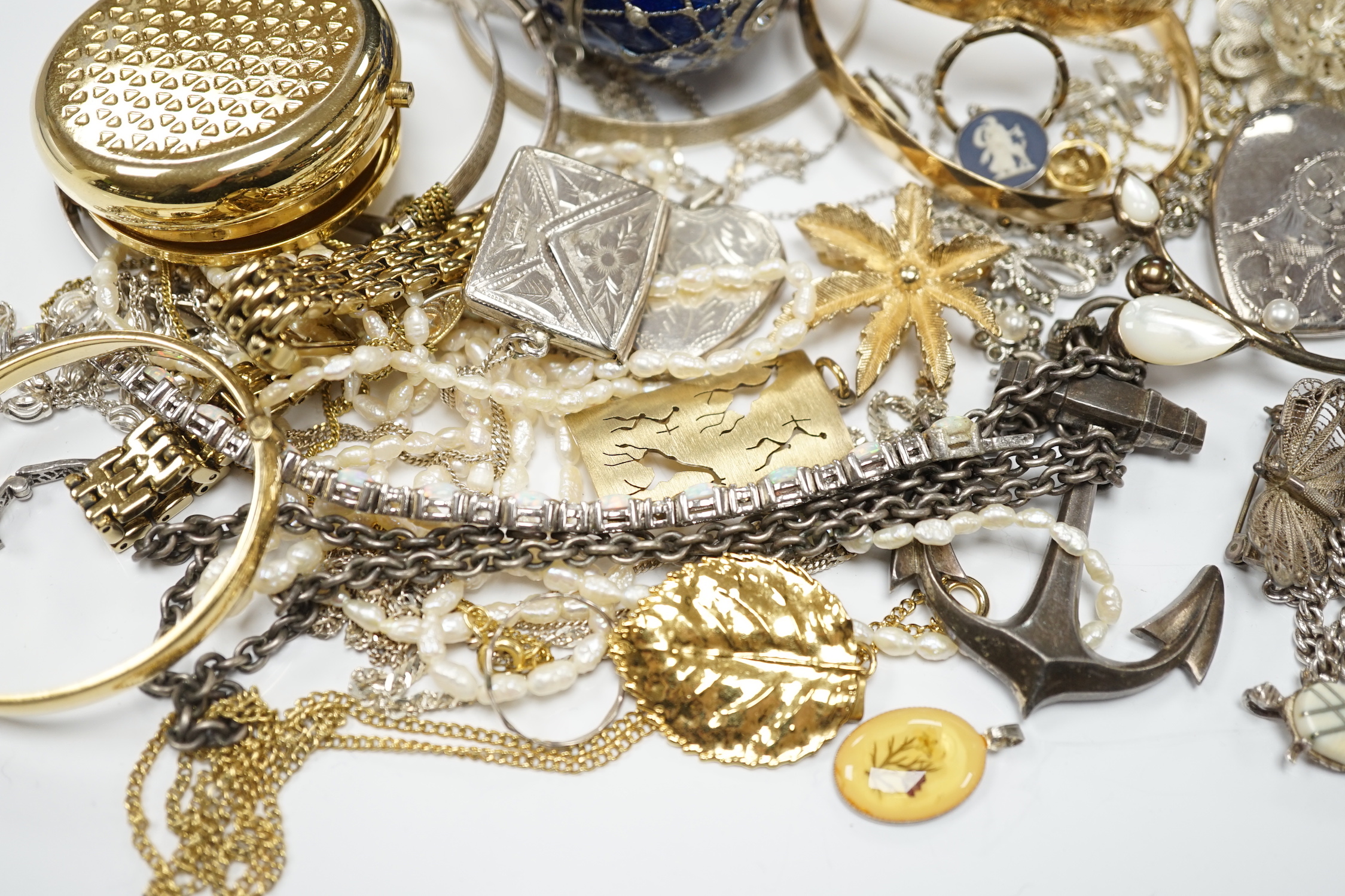 A quantity of assorted costume and silver jewellery including pendants, locket, bracelets, bangles, chains etc.